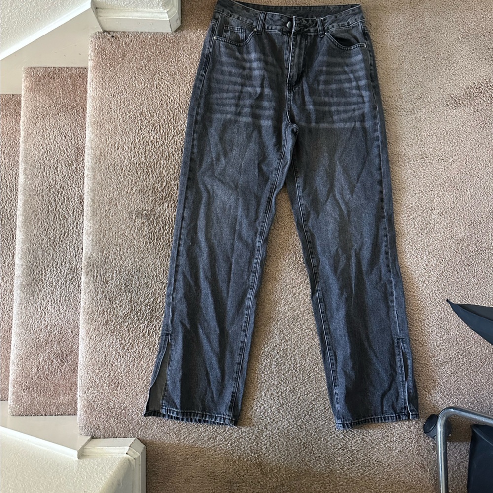 Size 30 Gray wide legged pants with split seen at the ankle.